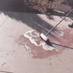 Applying Degreaser To Stains On Colored Concrete