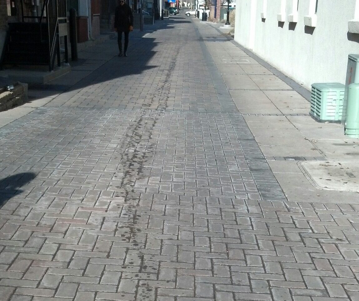 Oil Spill Running down pavers in Longmont, Colorado