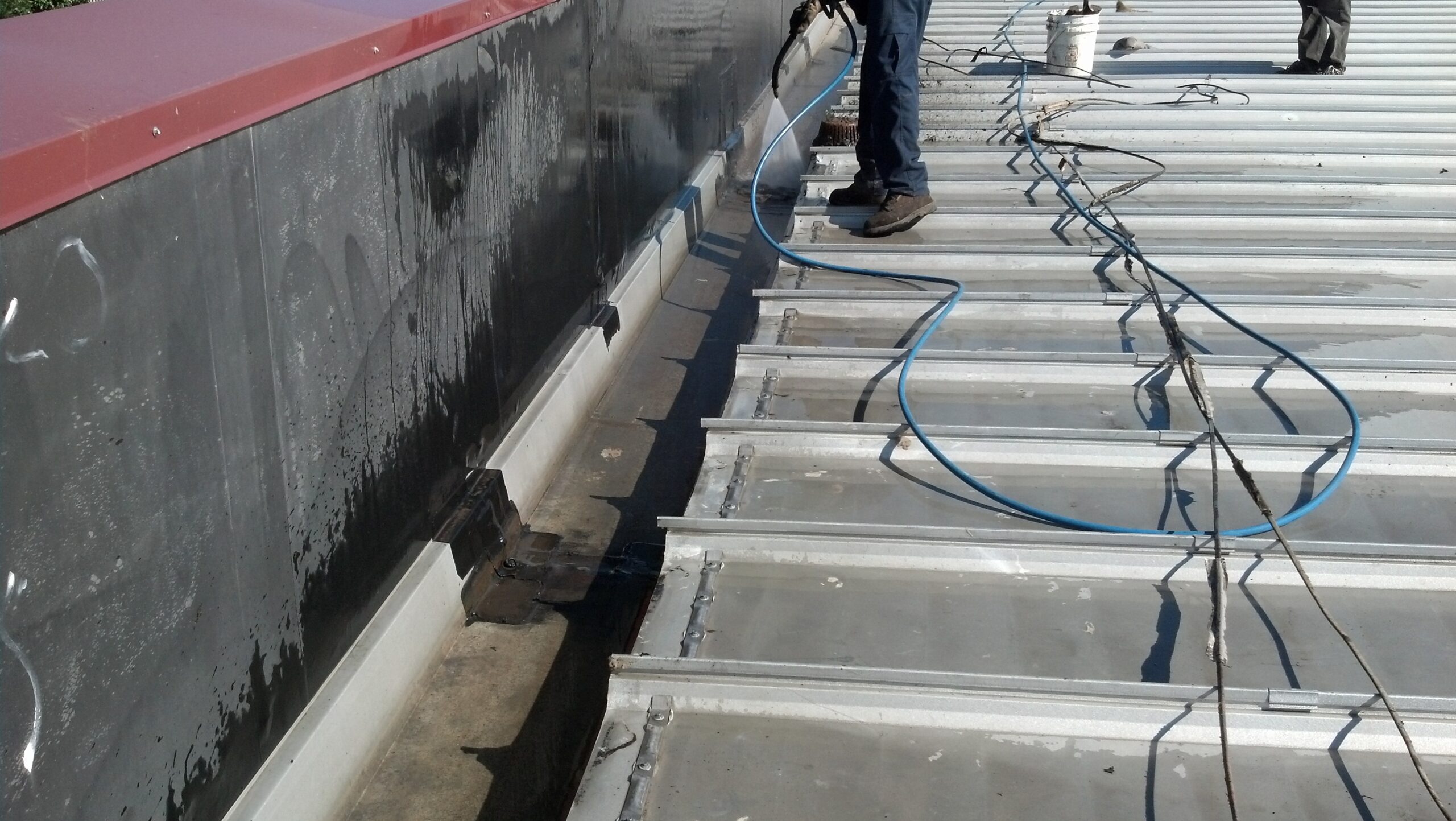 Pressure Washing the roof gutters on a commercial building in Denver, Colorado