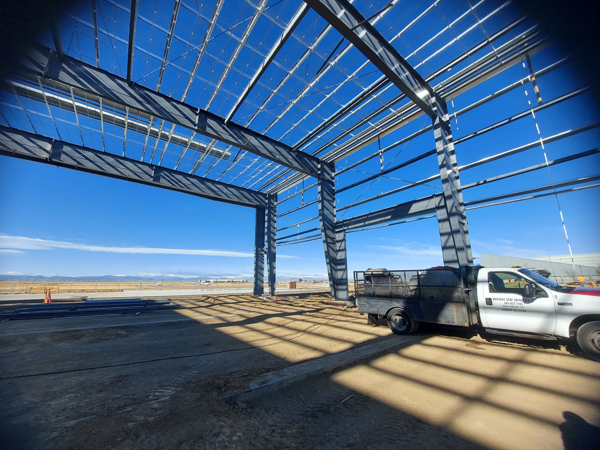 View of the Colorado Front Range while pressure washing an airport hanger in Centennial