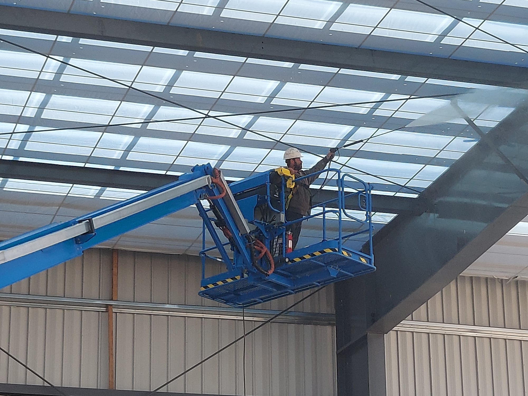 Cleaning dirt from the beams in a new airport hanger in Centennial, Colorado