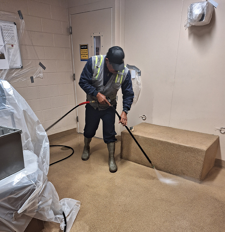 Pressure washing the holding cell and processing area at the Littleton, Colorado Police Department