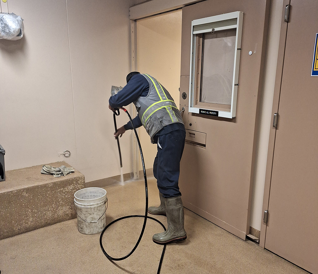 Pressure washing the holding cell and processing area at the Littleton, Colorado Police Department